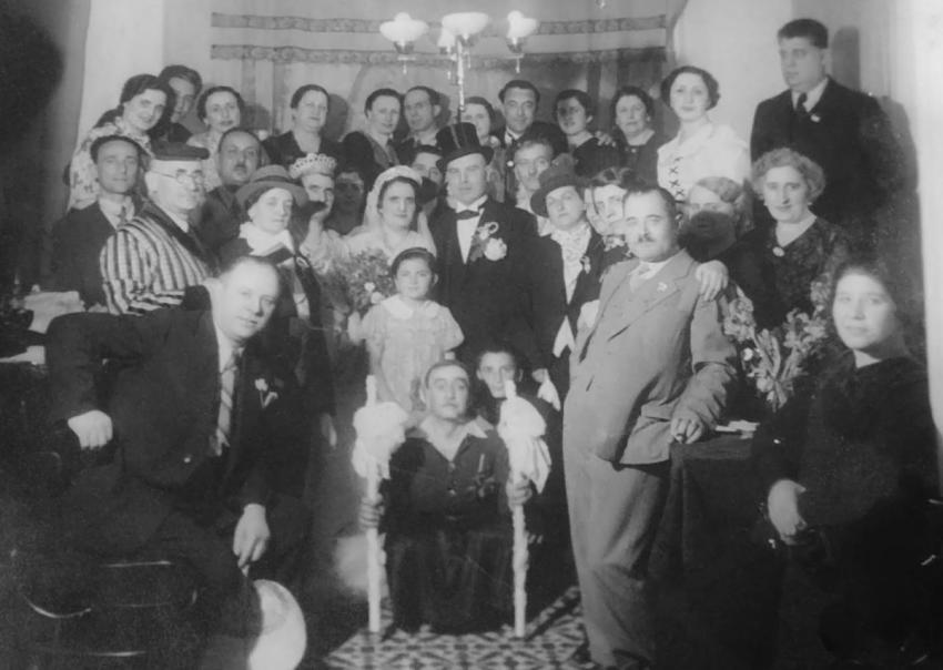 Purim party in the home of Jacques Toledano, head of the Varna Jewish community and his wife, Doda (center, dressed up as a bride and groom), 1937